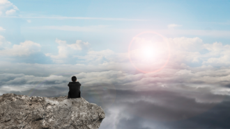 man looking at clouds