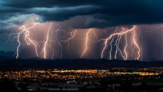 a photo of a series of simultaneous lightning strikes over a night landscape