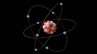 an illustration of an atom shows a nucleus composed of red and white dots to represent protons and neutrons, surrounded by blue dots that represent electrons