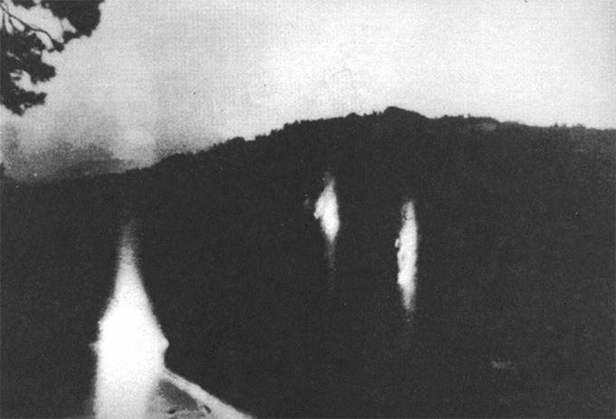 Three lights floating in a dark setting, in a black and white photo taken in a region that had experienced recent earthquakes.