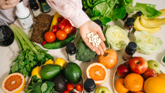 dietary bread, corn, tomatoes, avocado, celery, cabbage, apples, grapefruit, nuts, dietary supplements, vitamins lie beautifully on the table