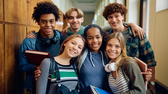 a diverse group of high school students smiling at the camera