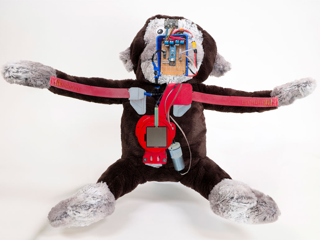 robotic parts laid on top of a huggable bot showing what the innards look like