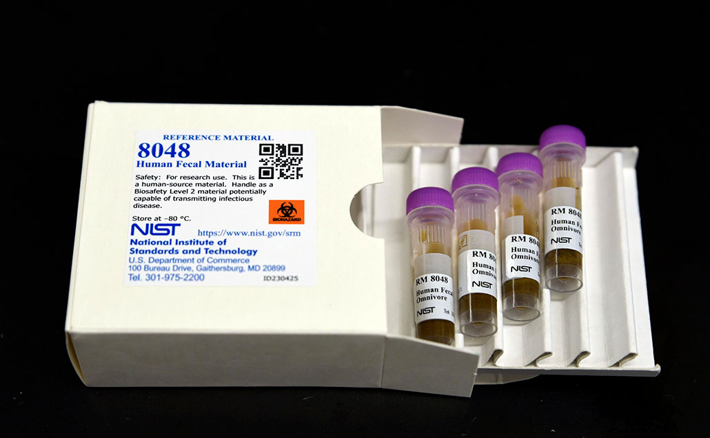 a box open to show several vials of standard reference material 8048, human fecal material