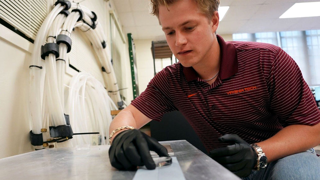a researcher puts an ice disk on the engineered aluminum surface in the lab
