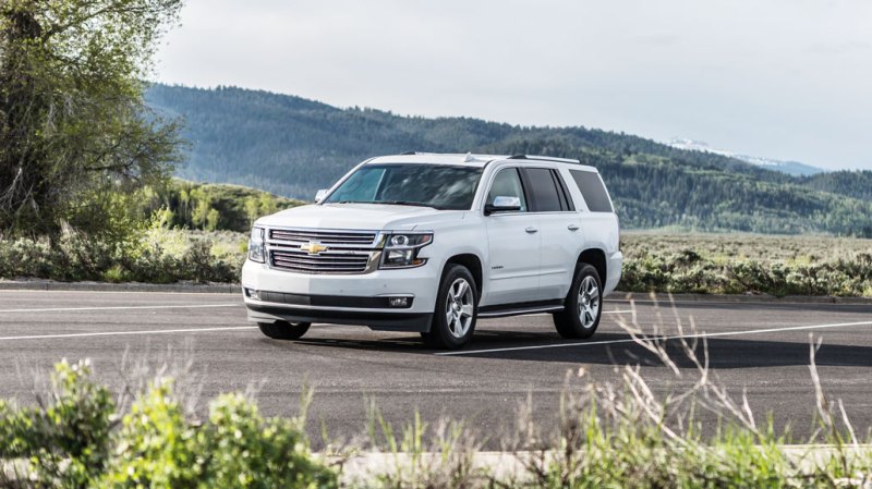 a photo of a white Chevy Tahoe in a parking lot